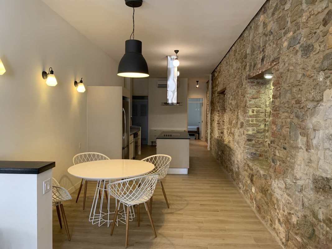 Contemporary living room with stone accent wall and leather furniture in Panama Colonial Condo