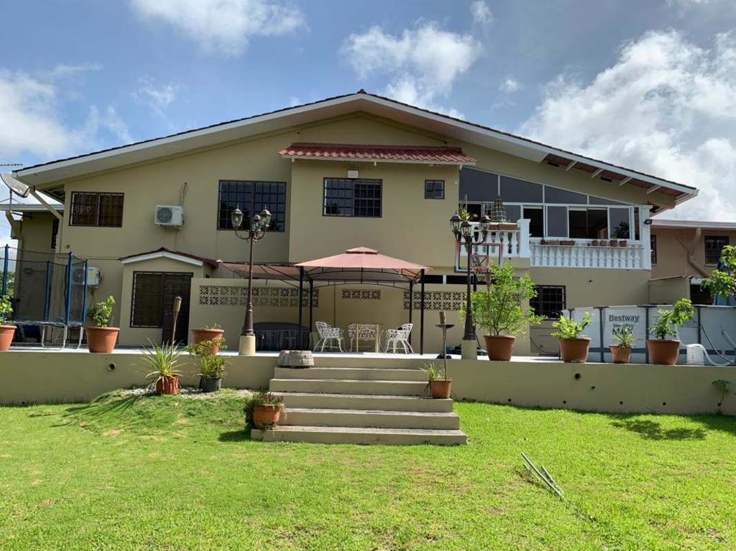 Outdoor pool, gazebo, trampolines, fruit trees in backyard at PH Las Guanábanas Clayton Panama