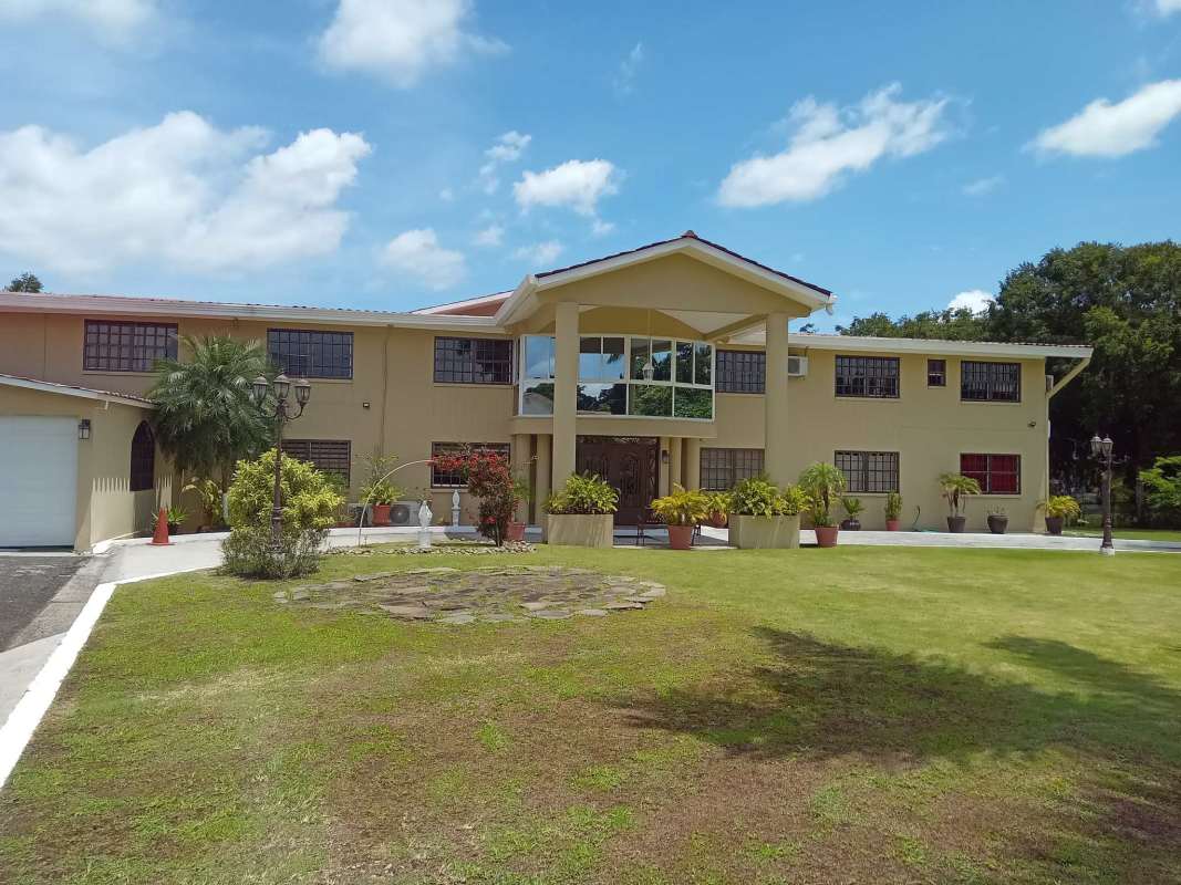 Beautiful landscaped garden and two-story buildings with balconies in PH Las Guanábanas Clayton Panama