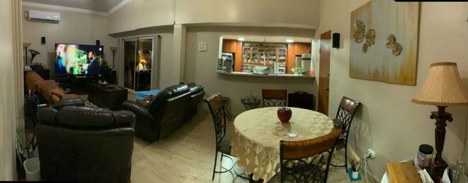 Living area with TV, leather sofas, dining space, large windows in PH Las Guanábanas Clayton
