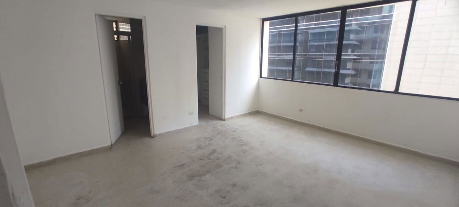 Bright living room area with large window and ceramic floors PH Monaco Panama