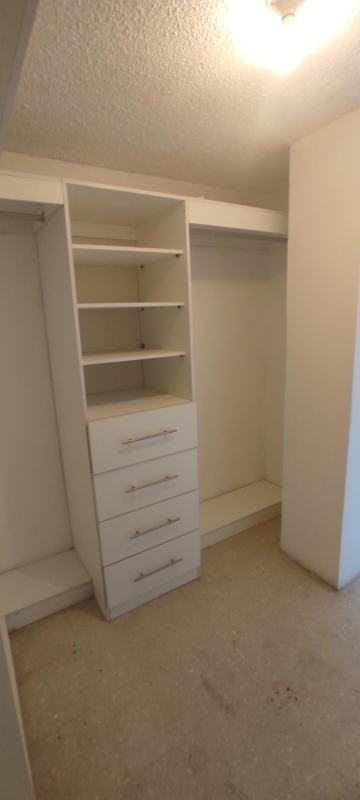 Large walk-in closet with built-in shelving in apartment PH Monaco Panama