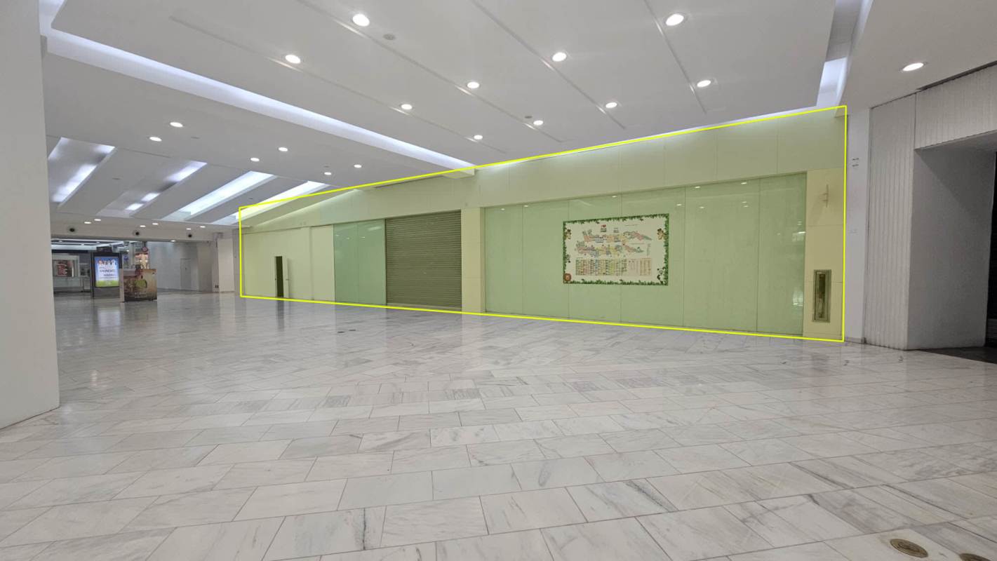 Vacant retail storefront with glass frontage roller doors in Albrook Mall Panama