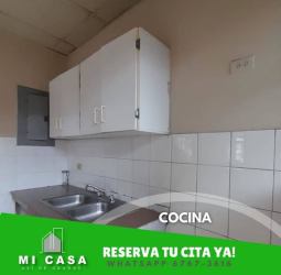 Simple kitchen with tiled backsplash, sink, and cabinets in Miraflores Penonomé house for rent