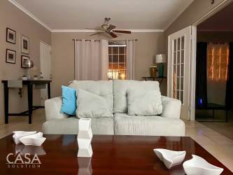 Dining space with large window, fan, modern furniture, bright atmosphere Villa María David Panama