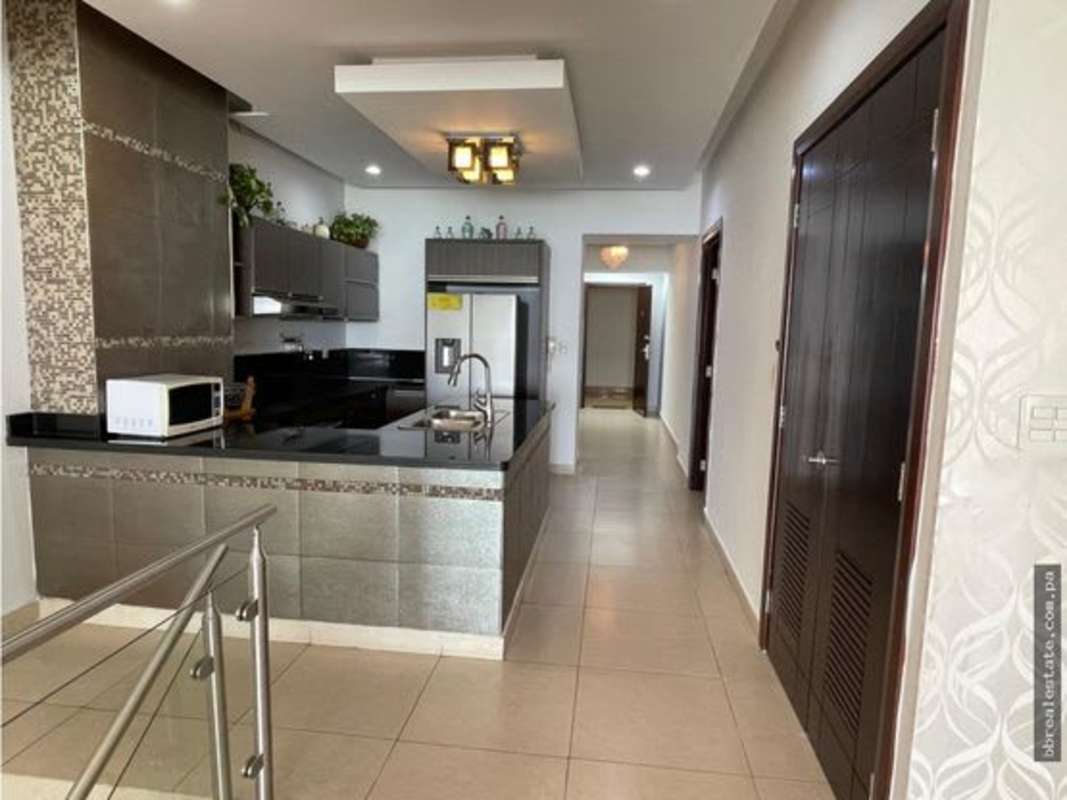 Sleek modern kitchen with granite countertops and stainless appliances in PH Rivage Avenida Balboa Panama City