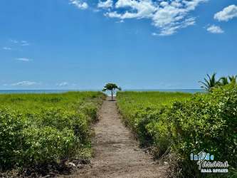 Sandy path leading to Pacific Ocean beachfront lot at Barqueta Nice Panama