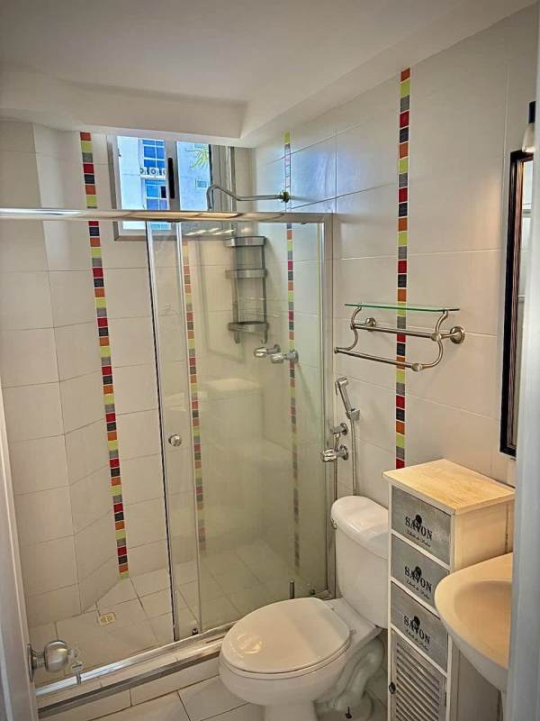 Apartment entrance lobby with metal door, decorative plants, and bench seating at Villa de las Fuentes Tower Panama City