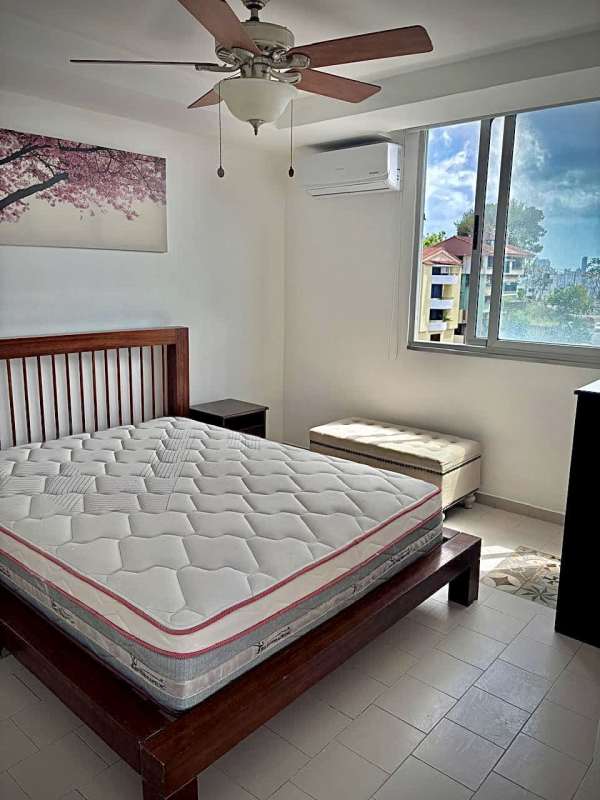 Furnished bedroom with queen bed, closet, split AC, ceiling fan and window view in Villa de las Fuentes Tower Panama