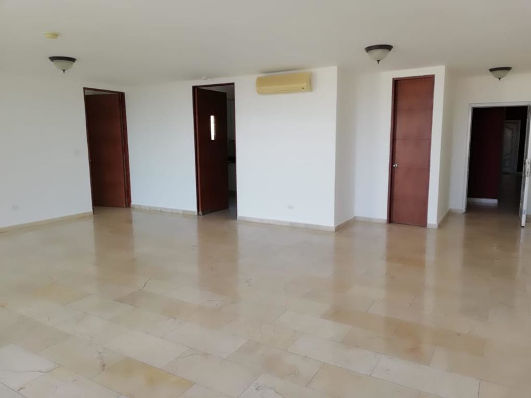 Empty living room with marble floors, large windows and balcony access PH Costa Pacifica Punta Pacifica