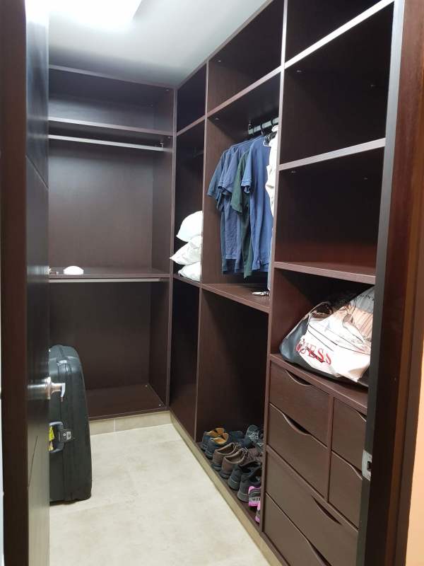 Spacious closet with wardrobes shoes and hangers in Embassy Village Clayton