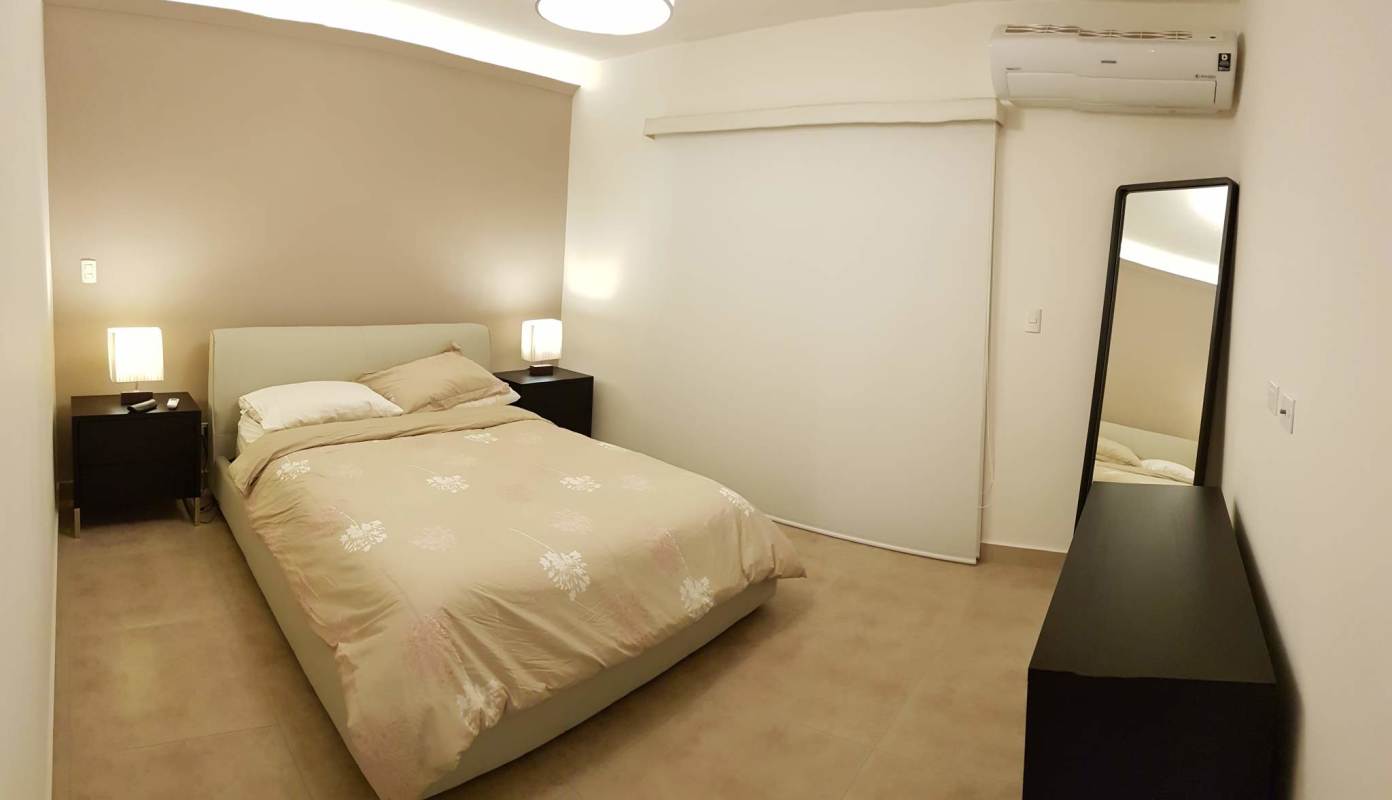 Modern bathroom with beige tiles, glass shower, vanity cabinet and rainfall showerhead Embassy Village