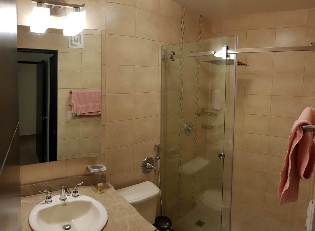 Minimalist bedroom with queen bed, AC, roller blinds and neutral tones Embassy Village Panama