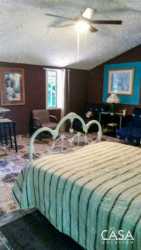 Spacious guest room with high ceilings and rustic decor in eco-hostel near Volcán Panama