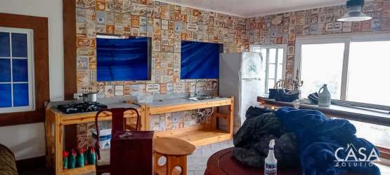 Rustic kitchen with vintage pattern tiles, wood finishes in eco-hostel Boquerón Chiriquí