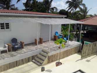 Covered patio with seating area tropical Coronado beach home for sale Panama