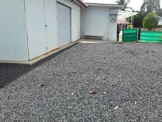 Garage with roll-up door gravel driveway luxury Coronado estate Panama