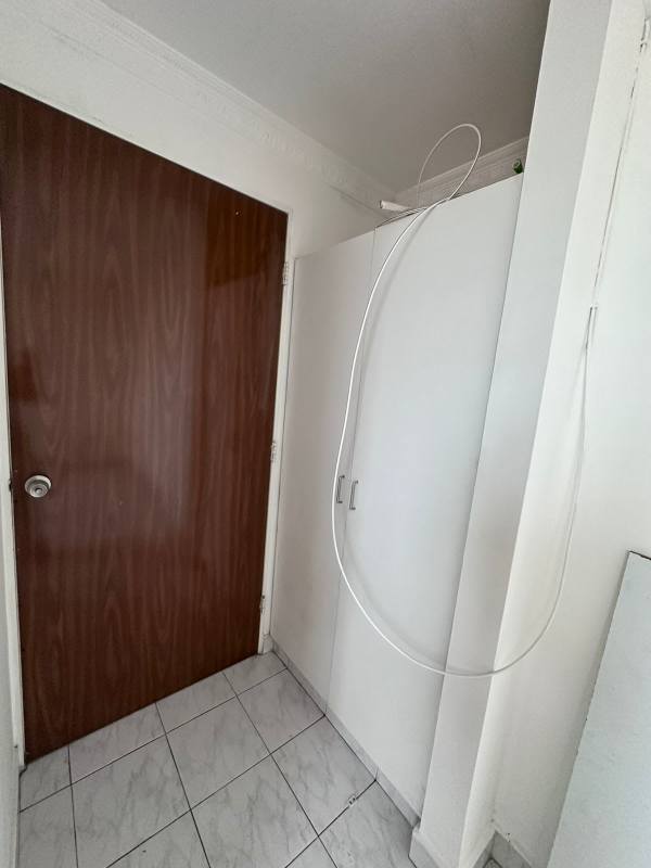 Small utility or storage area with cabinet and wood door at PH San Cristobal Panama City