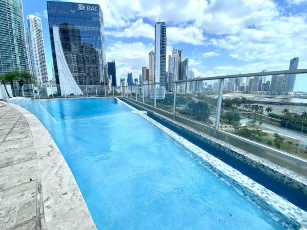 Spacious indoor lounge with wicker furniture and marble decor in PH White Panama City