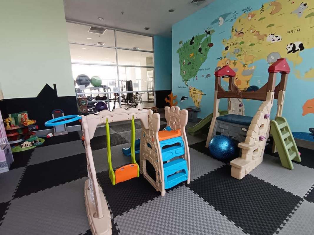 Colorful kids playroom with mural, slides, toys in PH White Avenida Balboa Panama