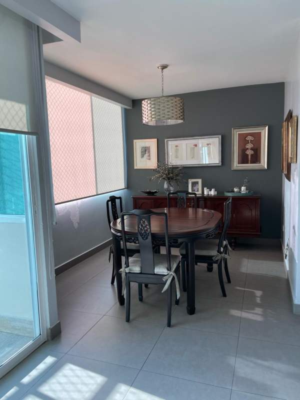 Bedroom with accent wall, artwork, wood headboard, ceiling fan and split AC in Coco del Mar Tower