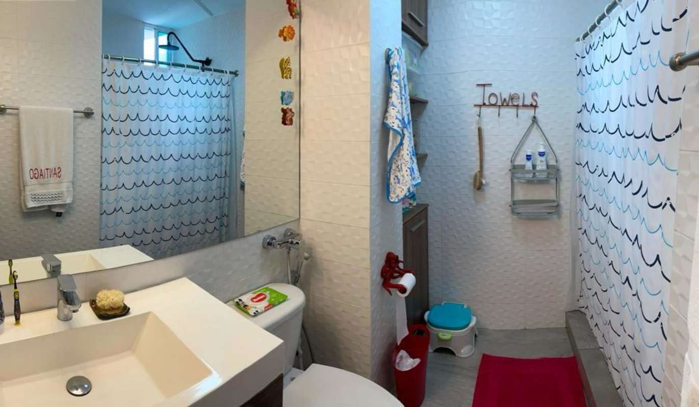 Children's playroom with toys, wall art, AC and gray curtains in Coco del Mar Tower Panama