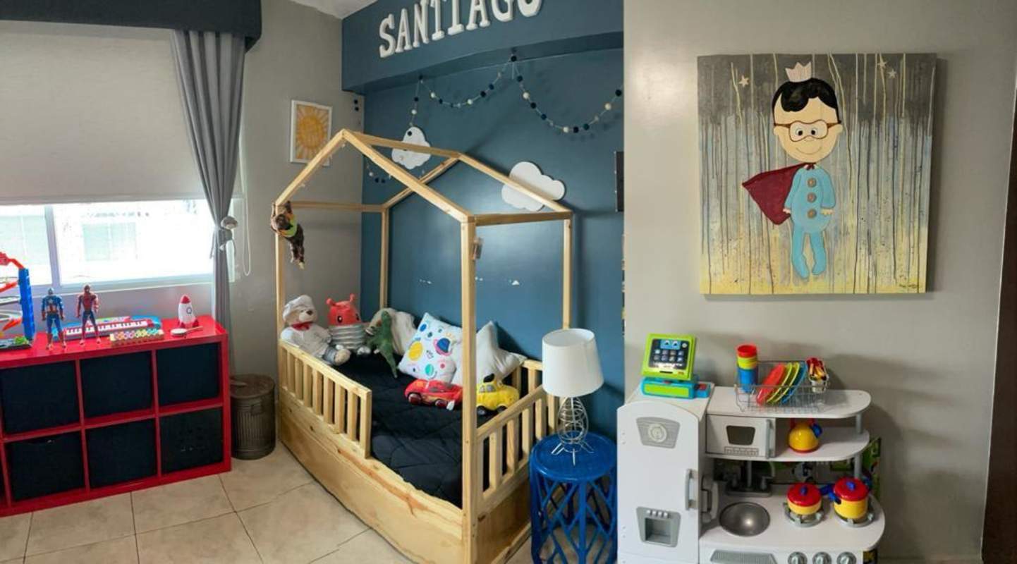 Kids room with wooden frame bed, toys, playful decor in Coco del Mar Tower Panama