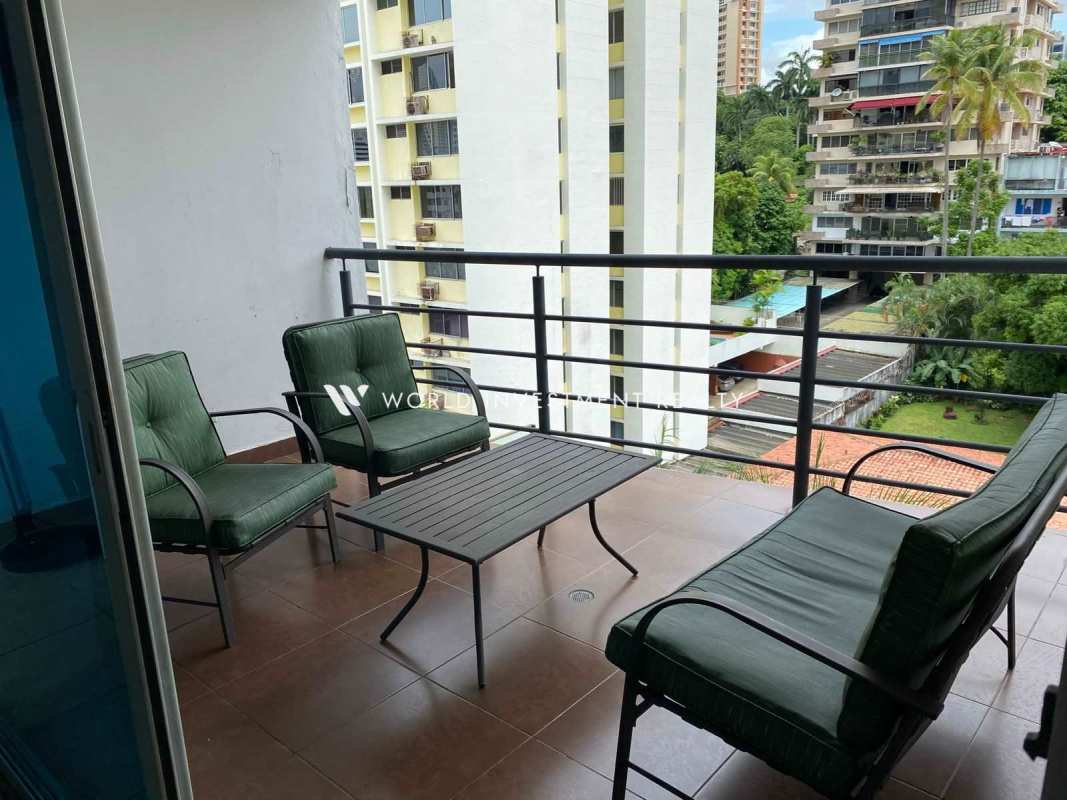 City view balcony with sofa set and green cushions at PH Park City El Cangrejo Panama City
