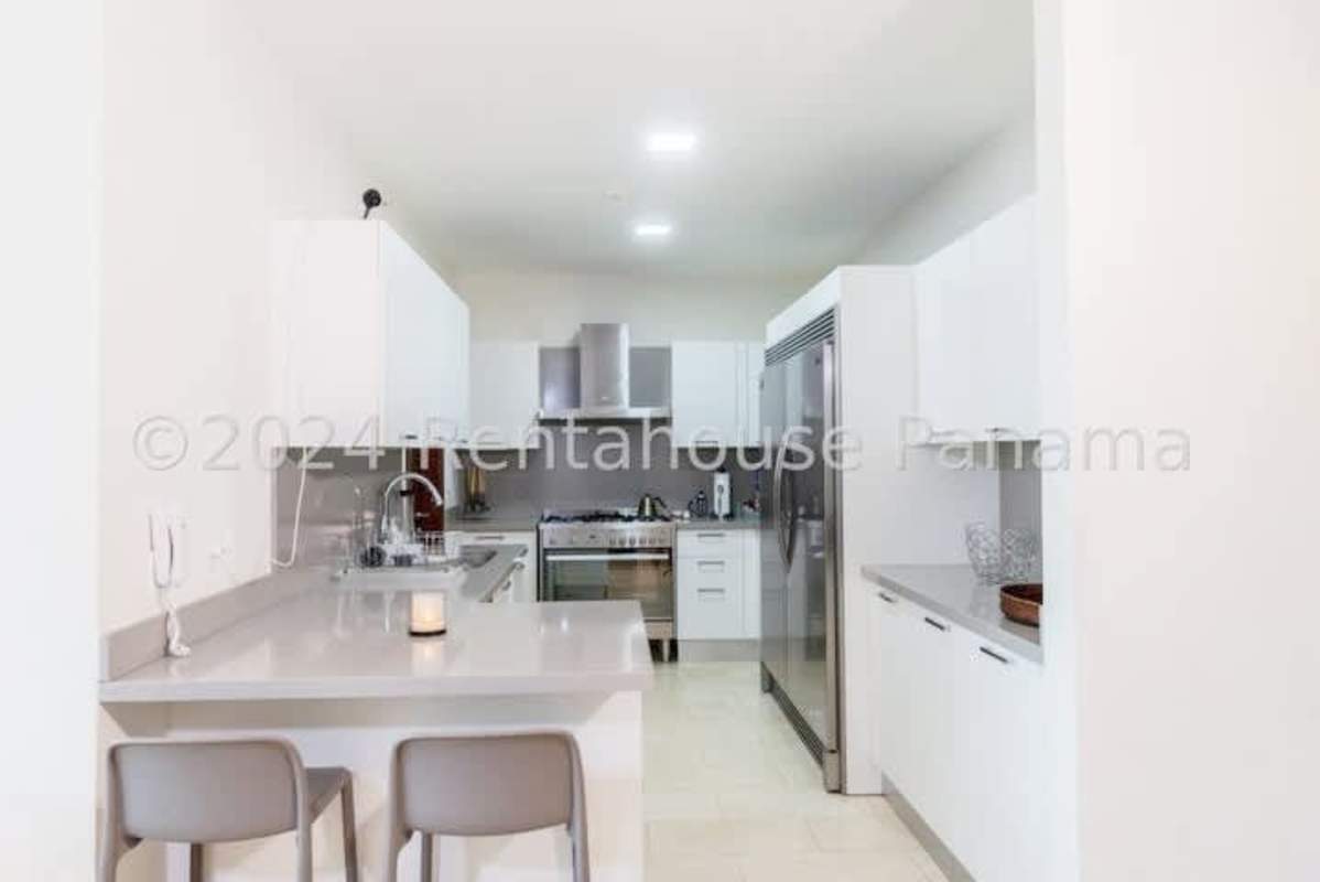 Elegant bathroom with marble tiles, large mirrors and designer fixtures in Santa Maria Panama apartment