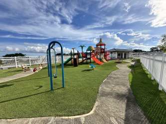 Children's playground with green gardens inside Playa Dorada Veracruz Panama