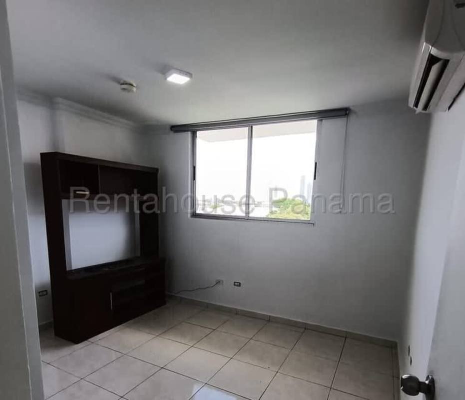 Bedroom with panoramic window, ceramic tiles, and ample closet space in Panama apartment