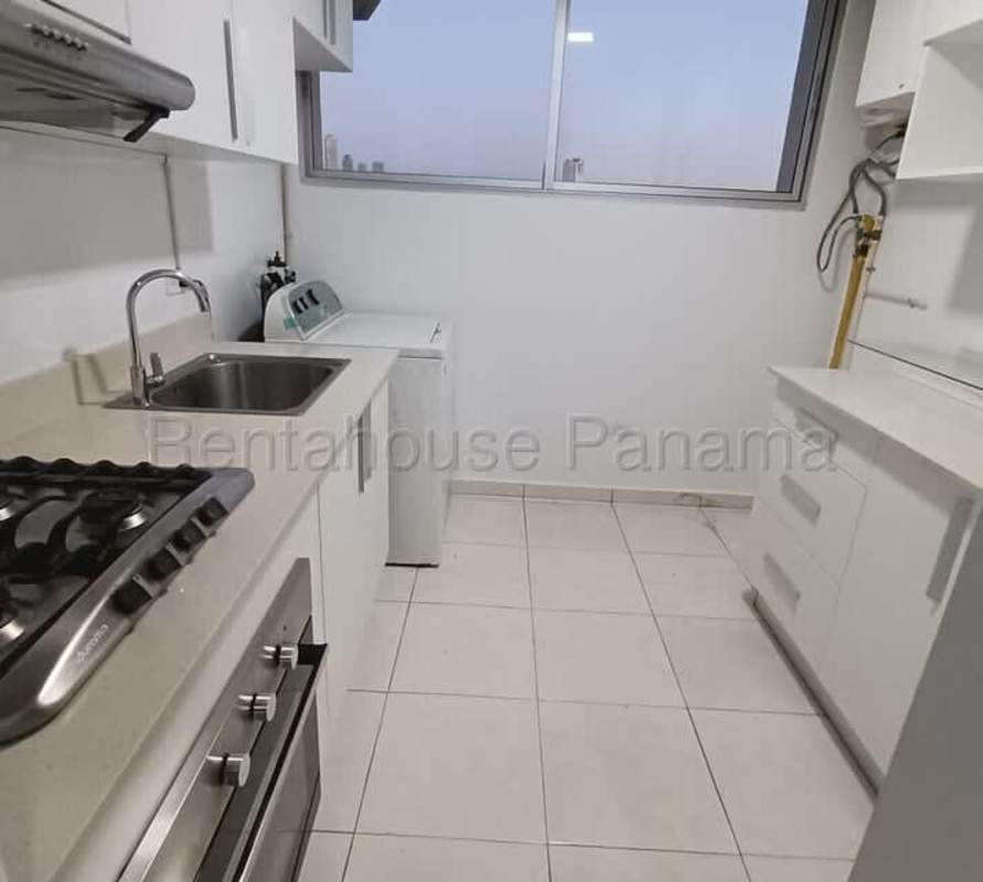 Compact remodeled kitchen with gas cooktop, oven, white cabinetry, in Panama City apartment