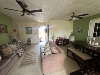 Spacious traditional kitchen with brown cabinetry and granite counters inside Villa Las Palmeras house Arraiján