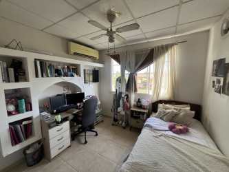 Outdoor patio seating surrounded by greenery at corner house Villa Las Palmeras Arraiján Panama