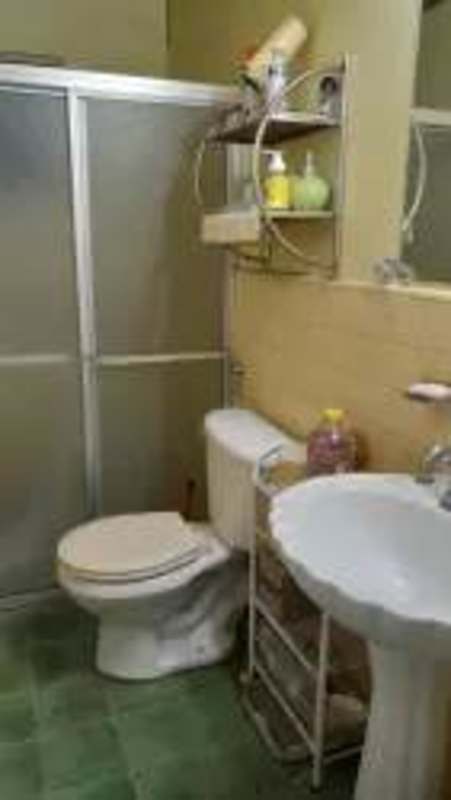 Kitchen with white cabinetry, double sink, stove in house for sale Villa Cáceres Panama