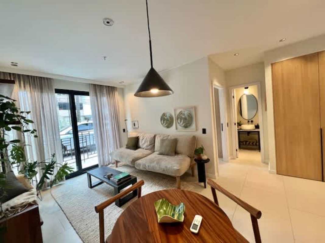 Living room with floor-to-ceiling glass, balcony access, and modern minimalist decor PH Amara Panama