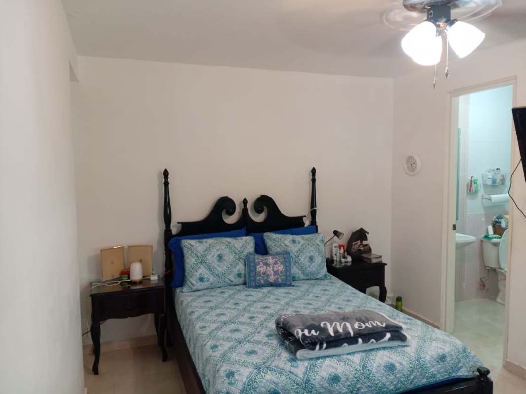 Traditional bedroom with dark wood bed and ensuite bath PH El Mare Edison Park Panama