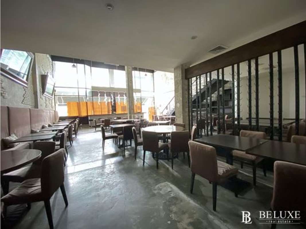 Open dining area with mezzanine, modern staircase, brick walls inside PH Plaza Obarrio Obarrio Panama