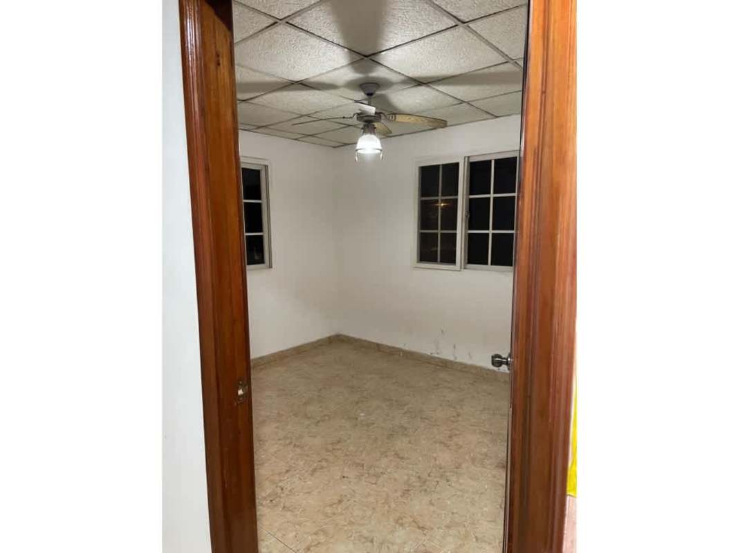 Kitchen with yellow cabinets, black trim, tile walls in rental house Pueblo Nuevo Panama City