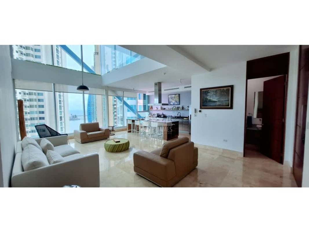 Contemporary open kitchen with granite island and appliances in Punta Pacifica apartment for sale