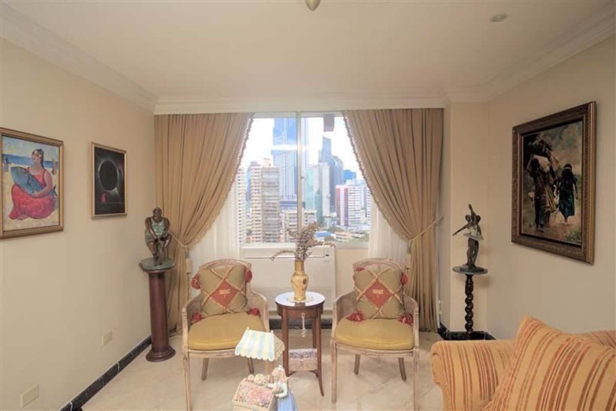 Luxury formal living room with classic decor, panoramic city skyline views at PH Lalique Punta Paitilla