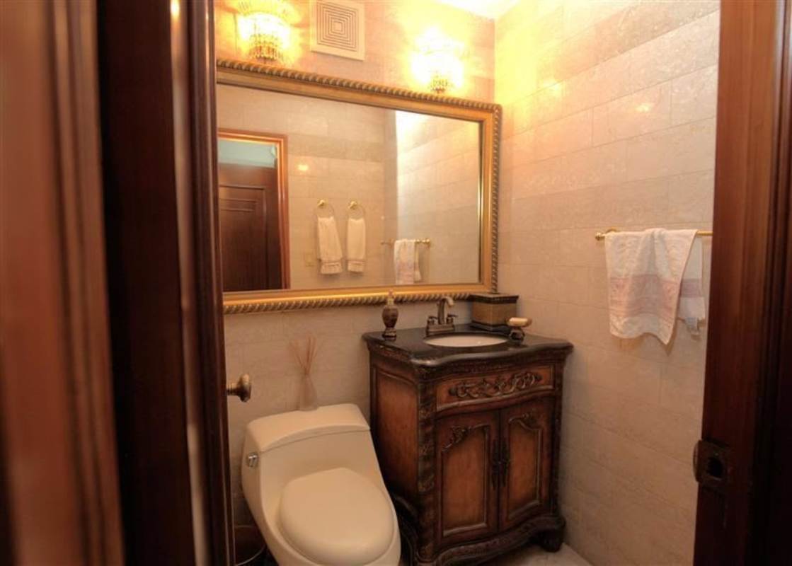 Traditionally designed bathroom with marble vanity, framed mirrors and classic finishes in PH Lalique