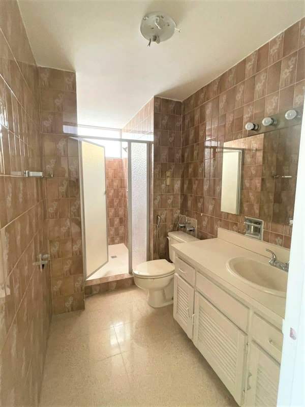 Spacious empty living room with marble floors and city view windows in PH Savoy