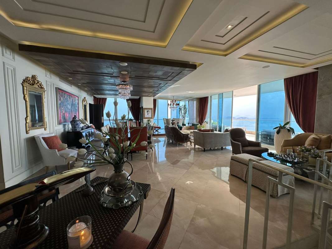 Luxury living room with ocean view floor-to-ceiling windows and marble floors The Point Punta Paitilla Panama
