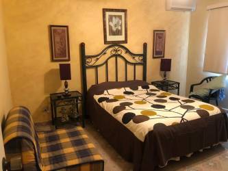 Traditional main bedroom with double bed tile floors in Coronado beach house Panama