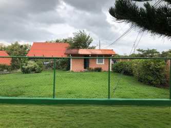 Brick house with large fenced green yard in Coronado beach community Panama