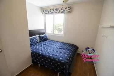 Spacious living area with tall windows facing Pacific Ocean inside duplex in PH Miramar Loft Farallón Panama