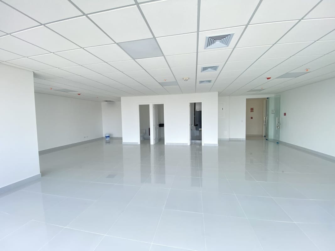 Modern office with tiled floors, ocean skyline backdrop, large bright windows at PH Interplus Avenida Balboa Panama