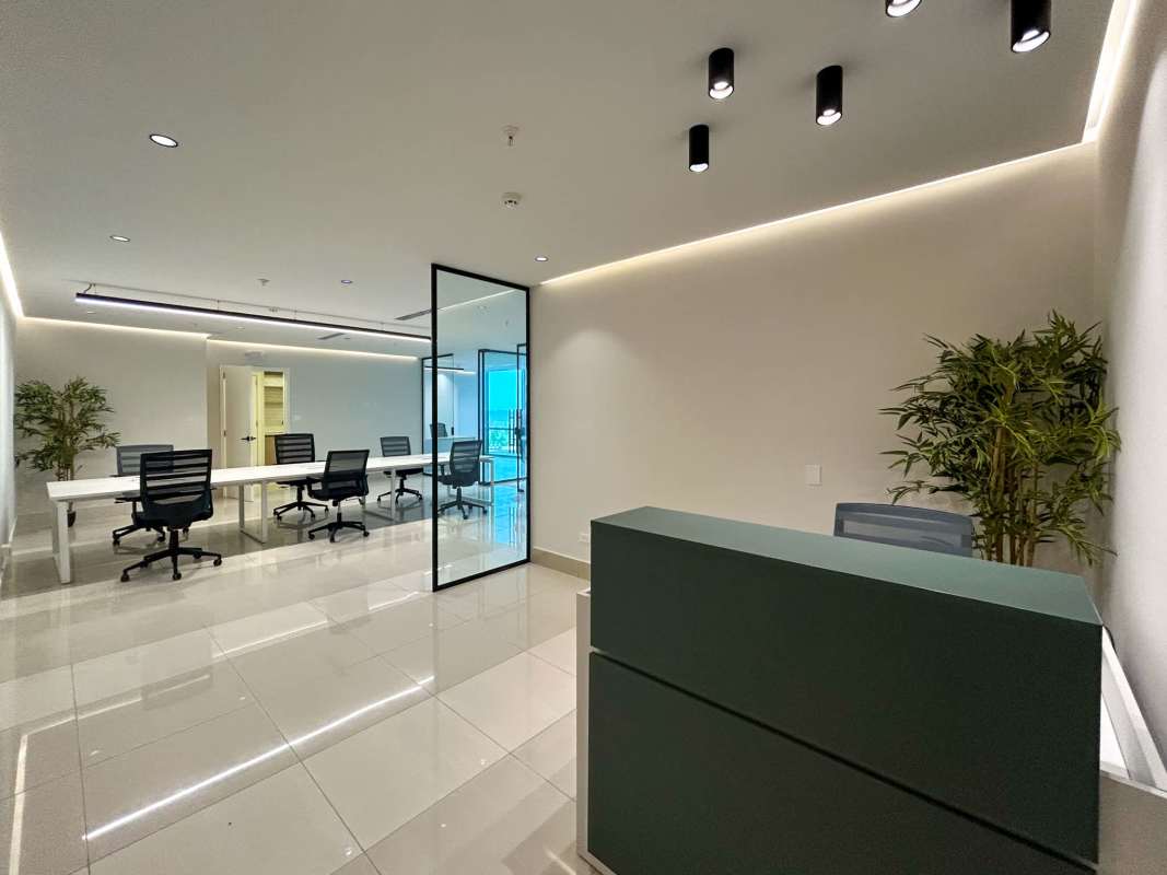 Reception area and entrance with glass walls and seating at Costa del Este Business Tower Panama