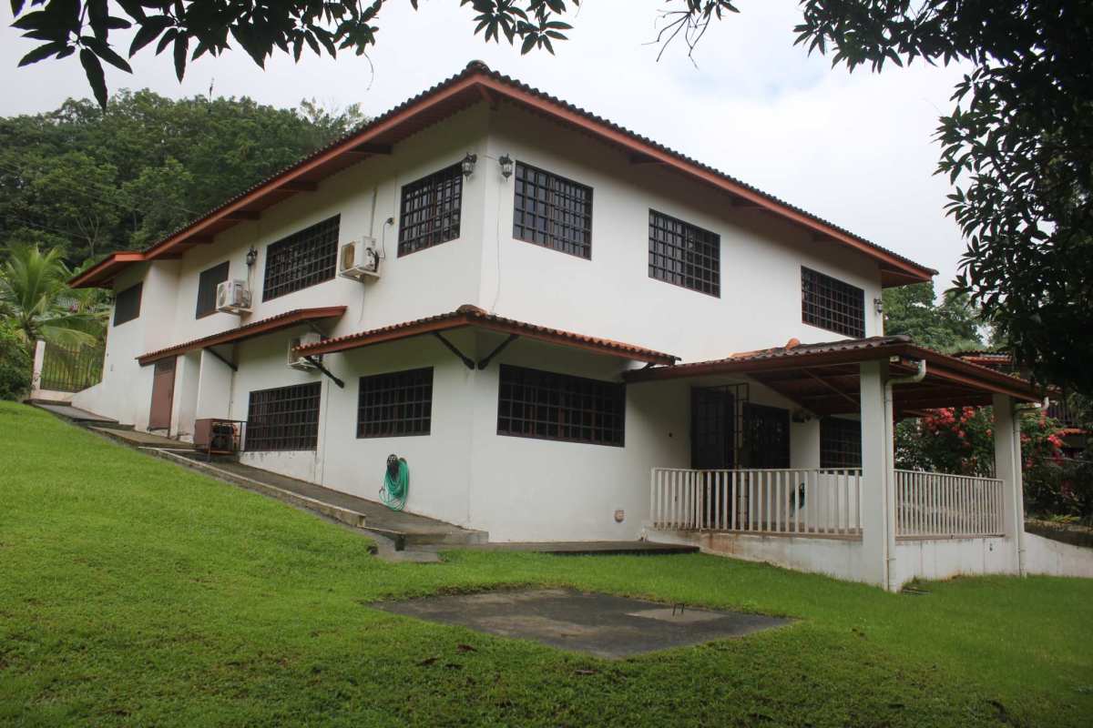 Exterior street view with fenced yard, tiled roof, garden plants in Quinta Valentina Las Lajas Panama
